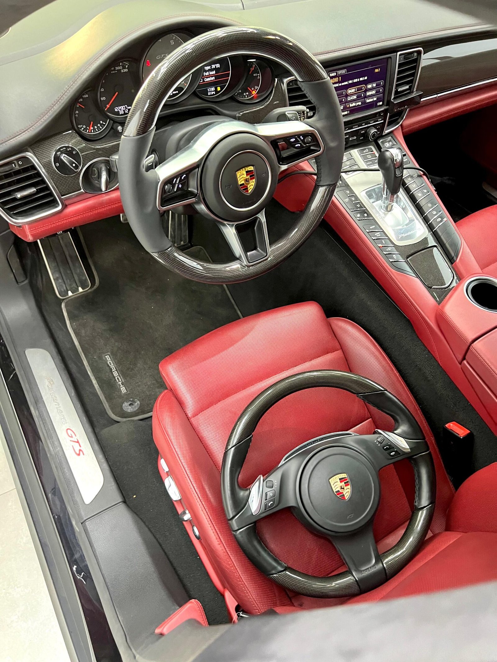 Porsche interior with black carbon fiber steering wheel